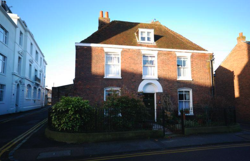 A large red brick house with a white door