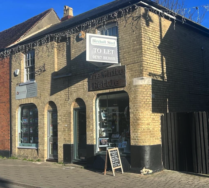 A brick building with a sign that says to let