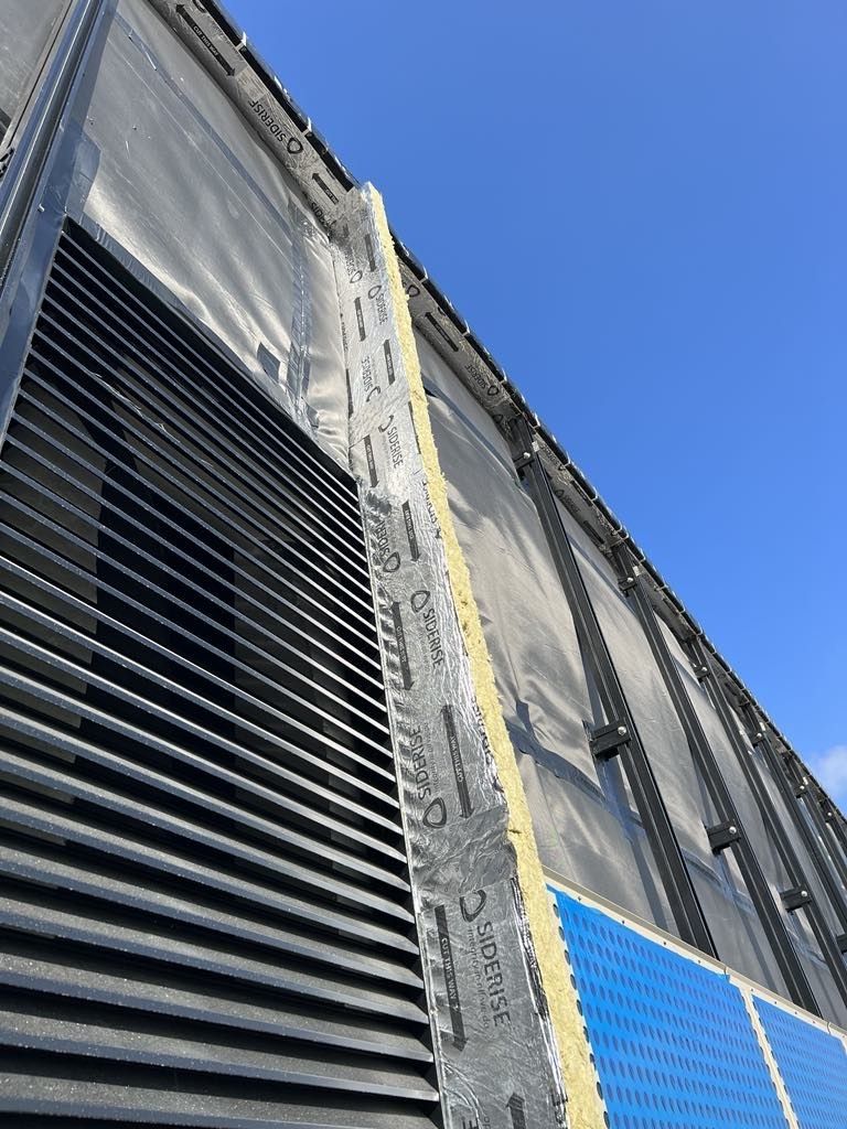 A group of people are looking at a blueprint on a table.