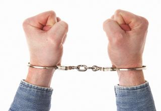 Man in handcuffs — Criminal Defense in Bellevue, NE