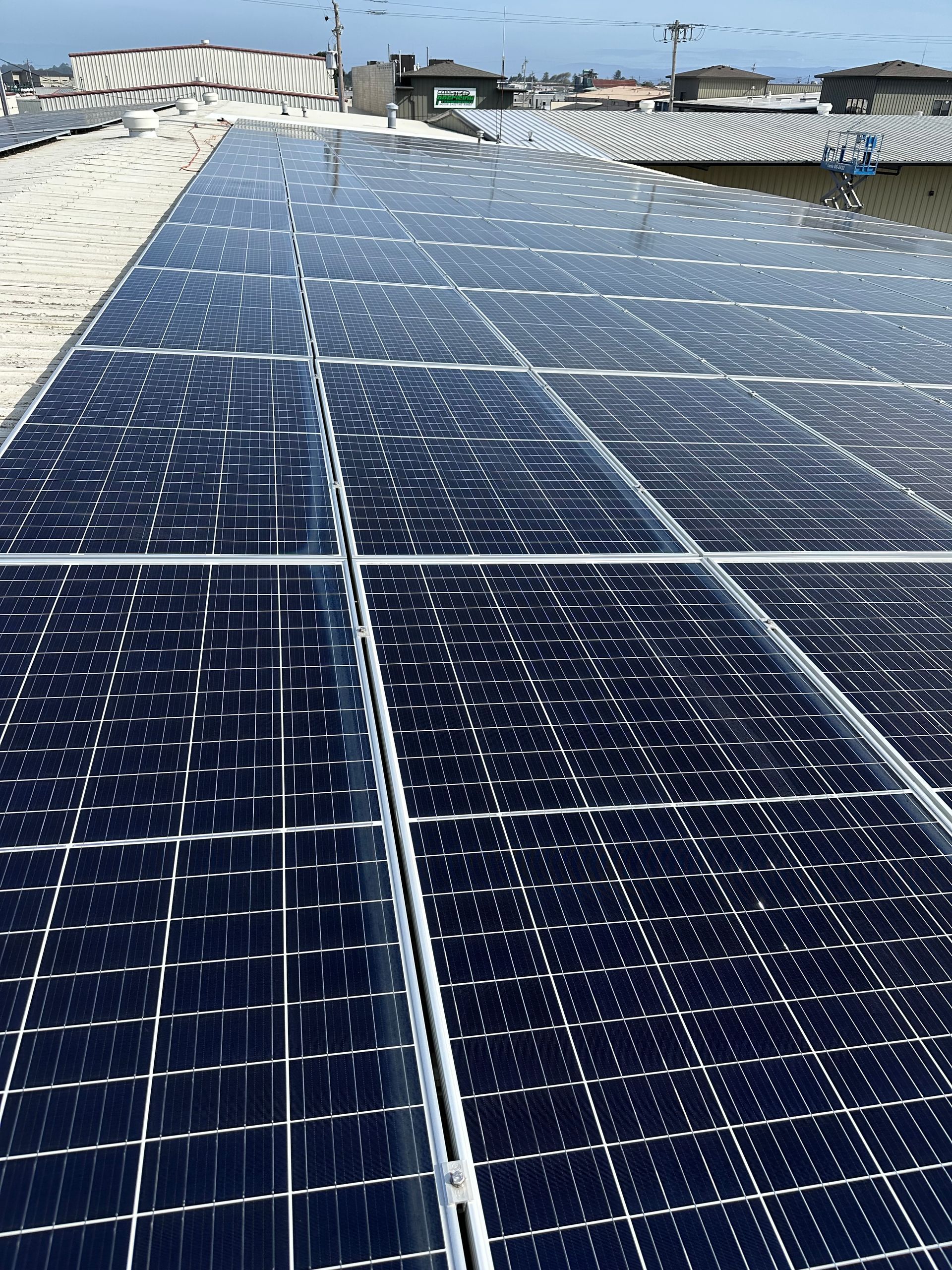 A row of solar panels on the roof of a building