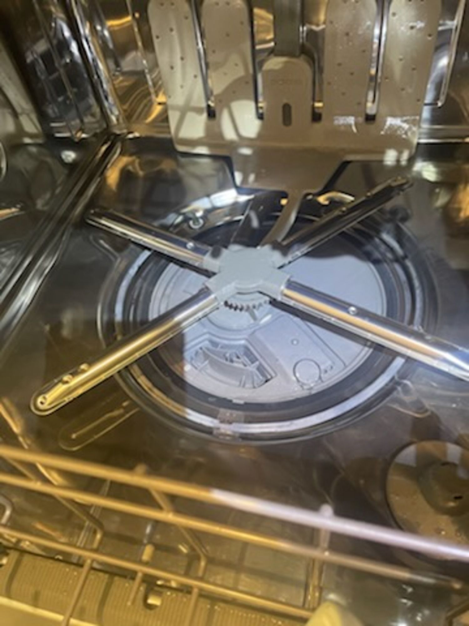 A close up of the inside of a dishwasher.