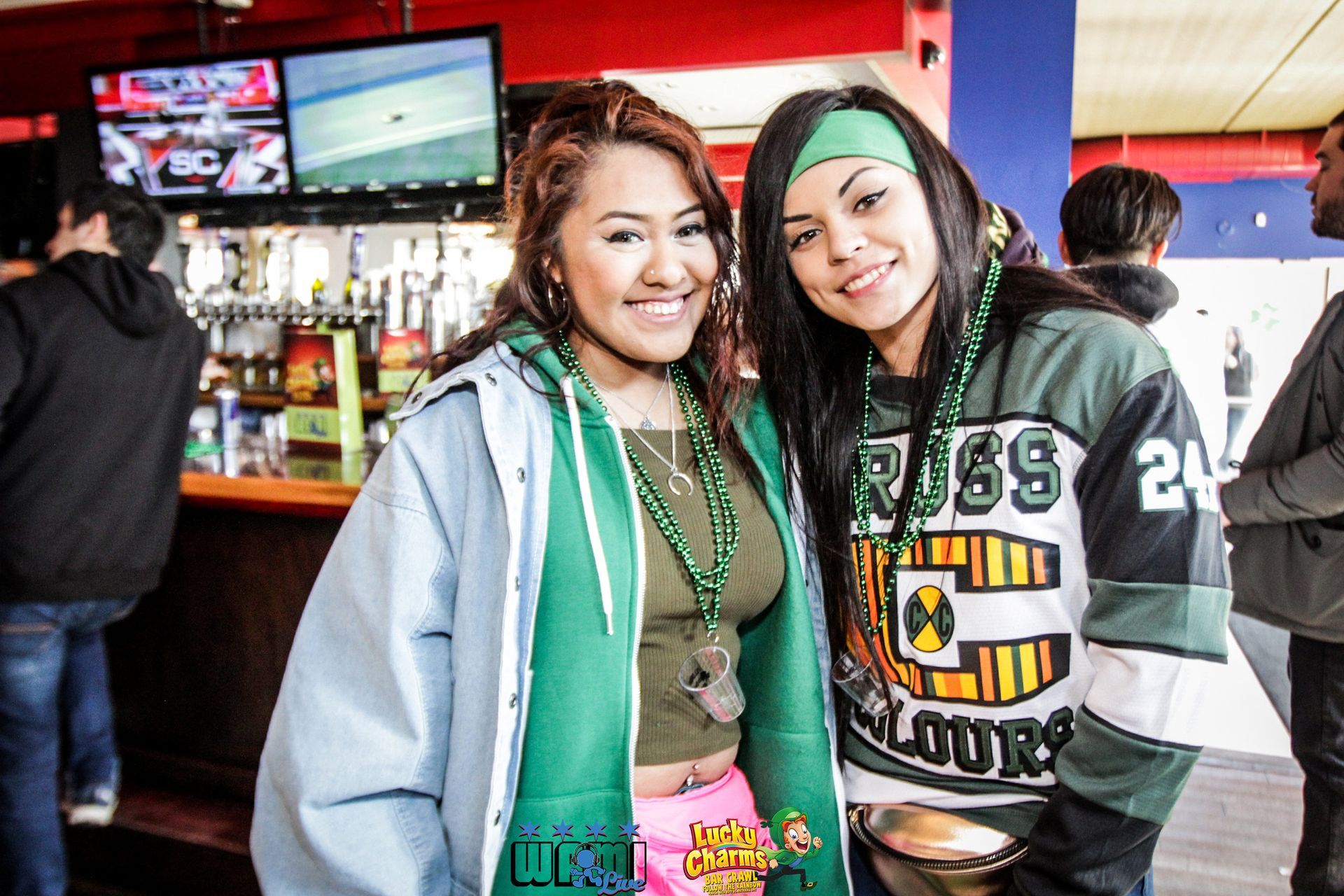 Two girls posing for a picture with one wearing a jersey that says russ 24