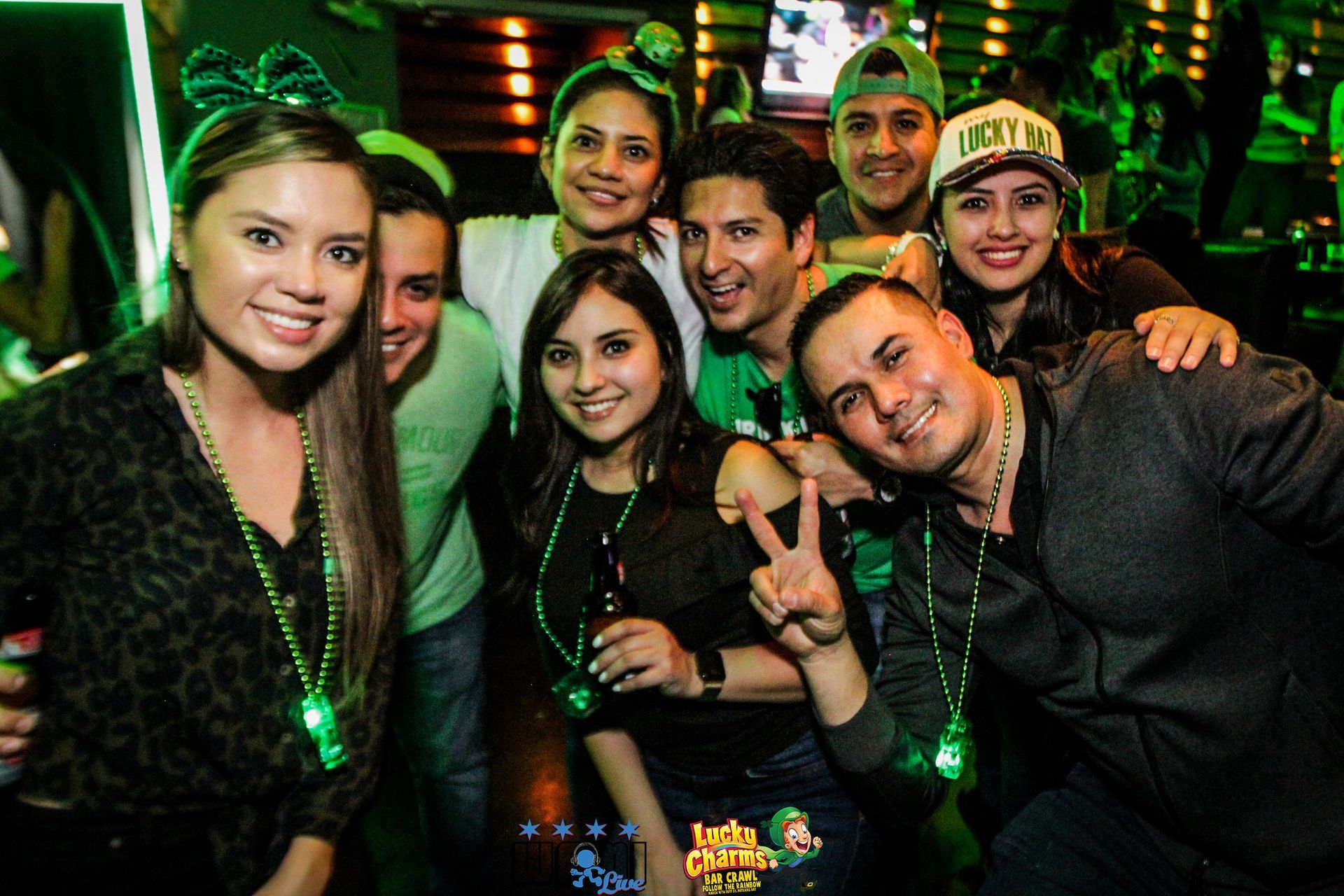 A group of people are posing for a picture in a bar.