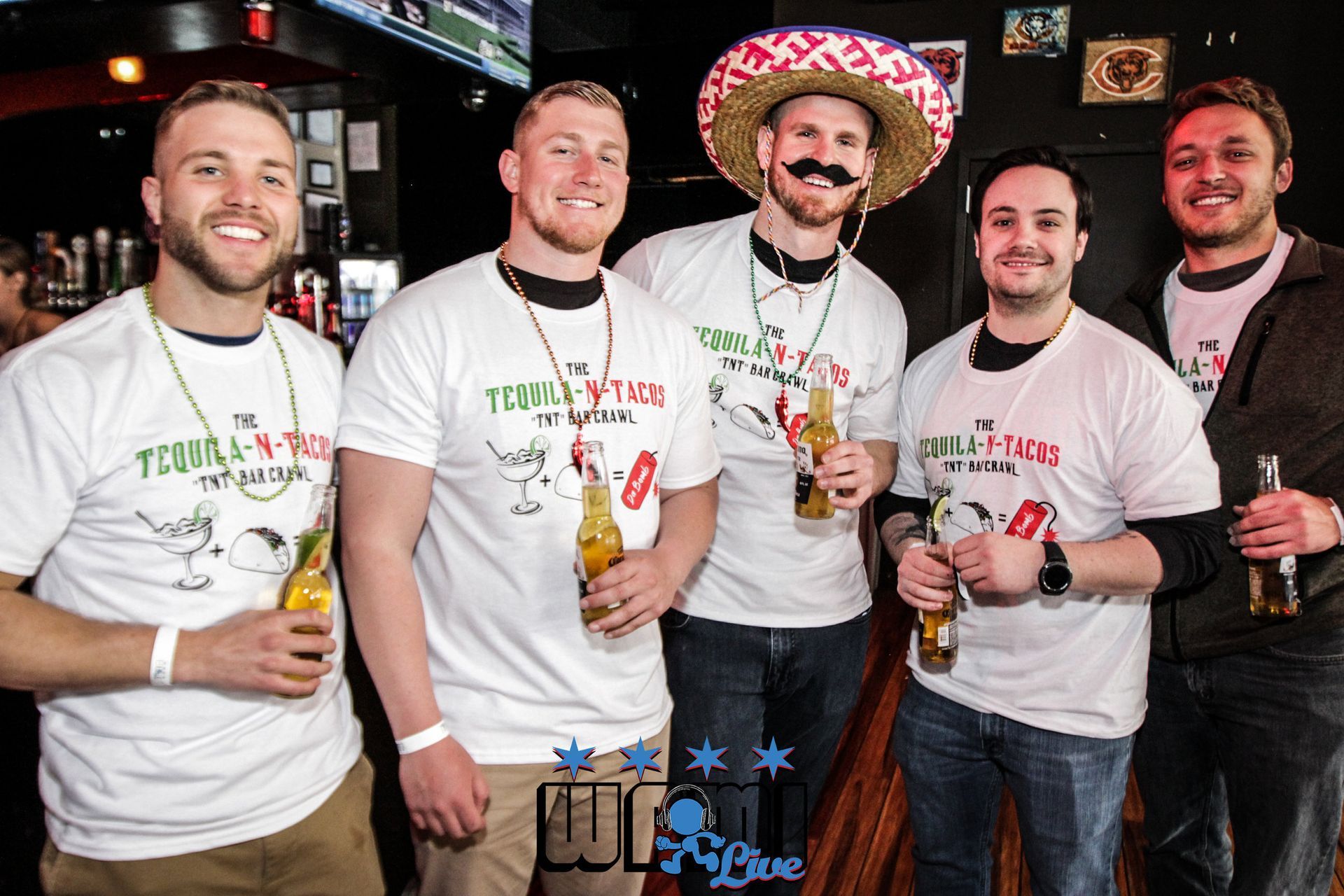 A group of men are posing for a picture and one of them is wearing a sombrero