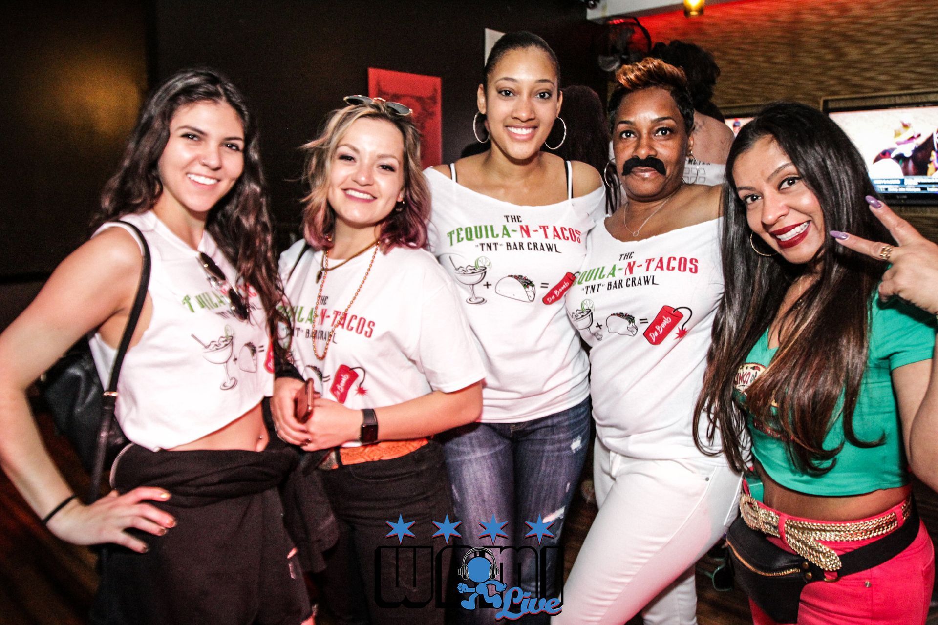 A group of women are posing for a picture together.