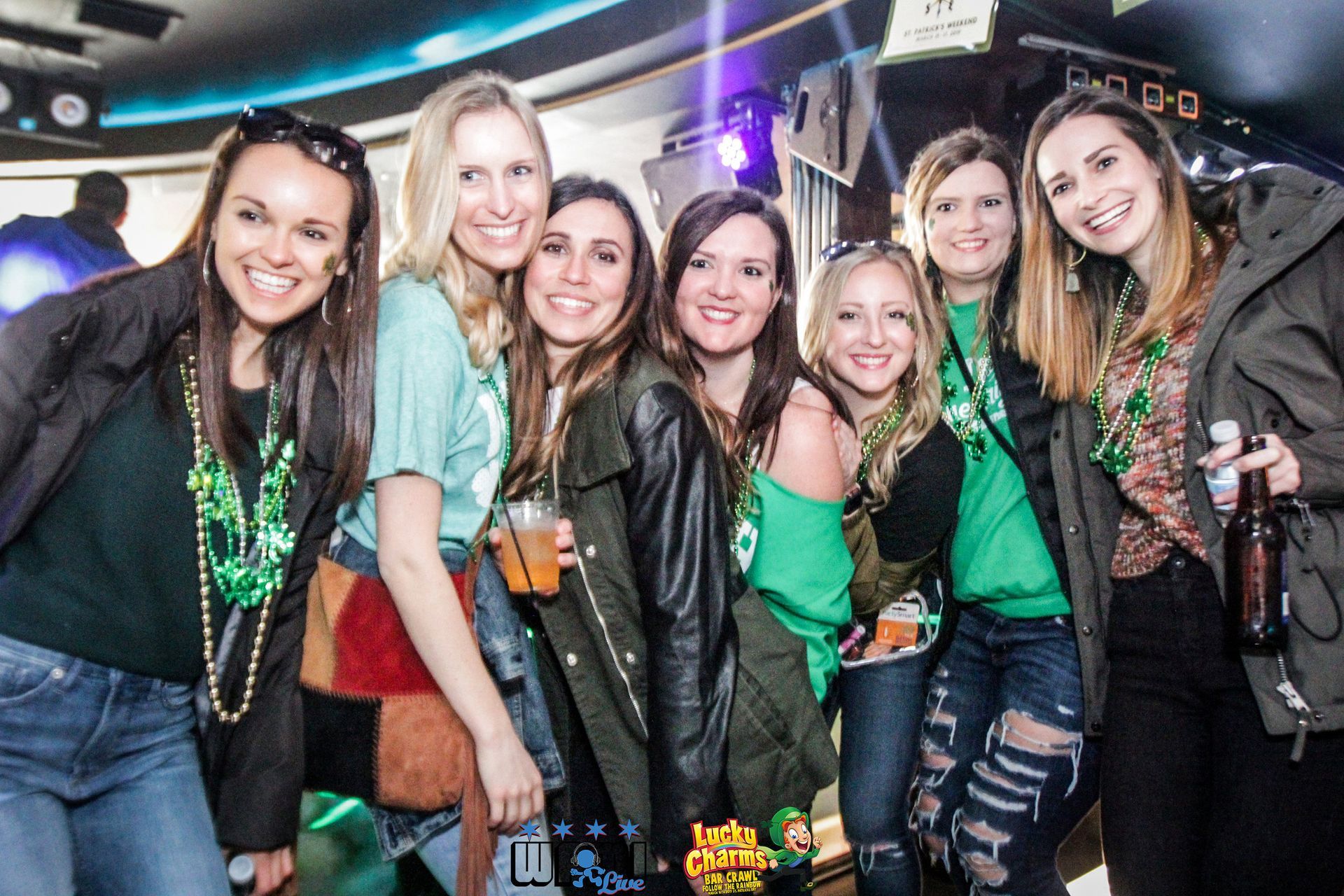 A group of women are posing for a picture at a party.