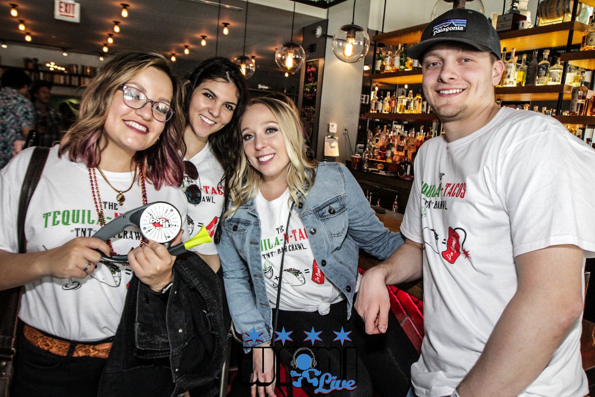 A group of people are posing for a picture in a restaurant.