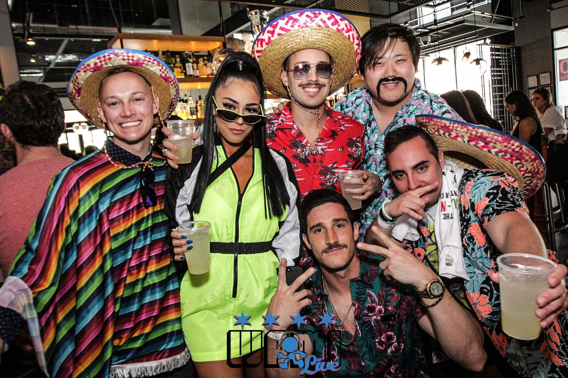 A group of people are posing for a picture at a party.