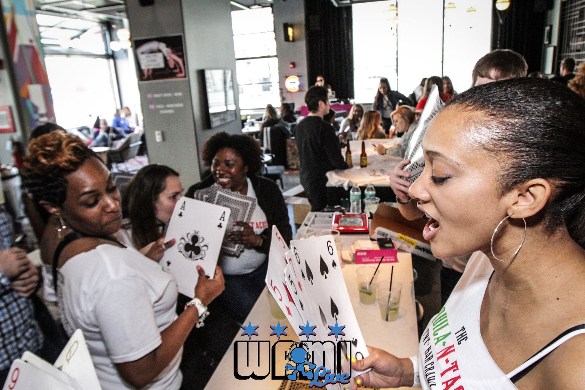 A woman holding a playing card with the word wow on it