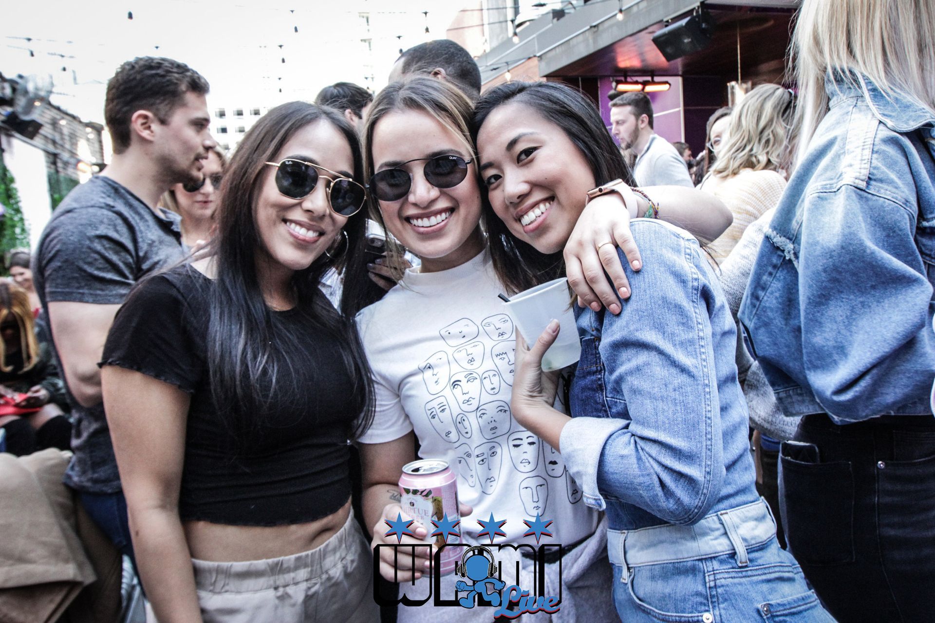 Three women are posing for a picture at a party.