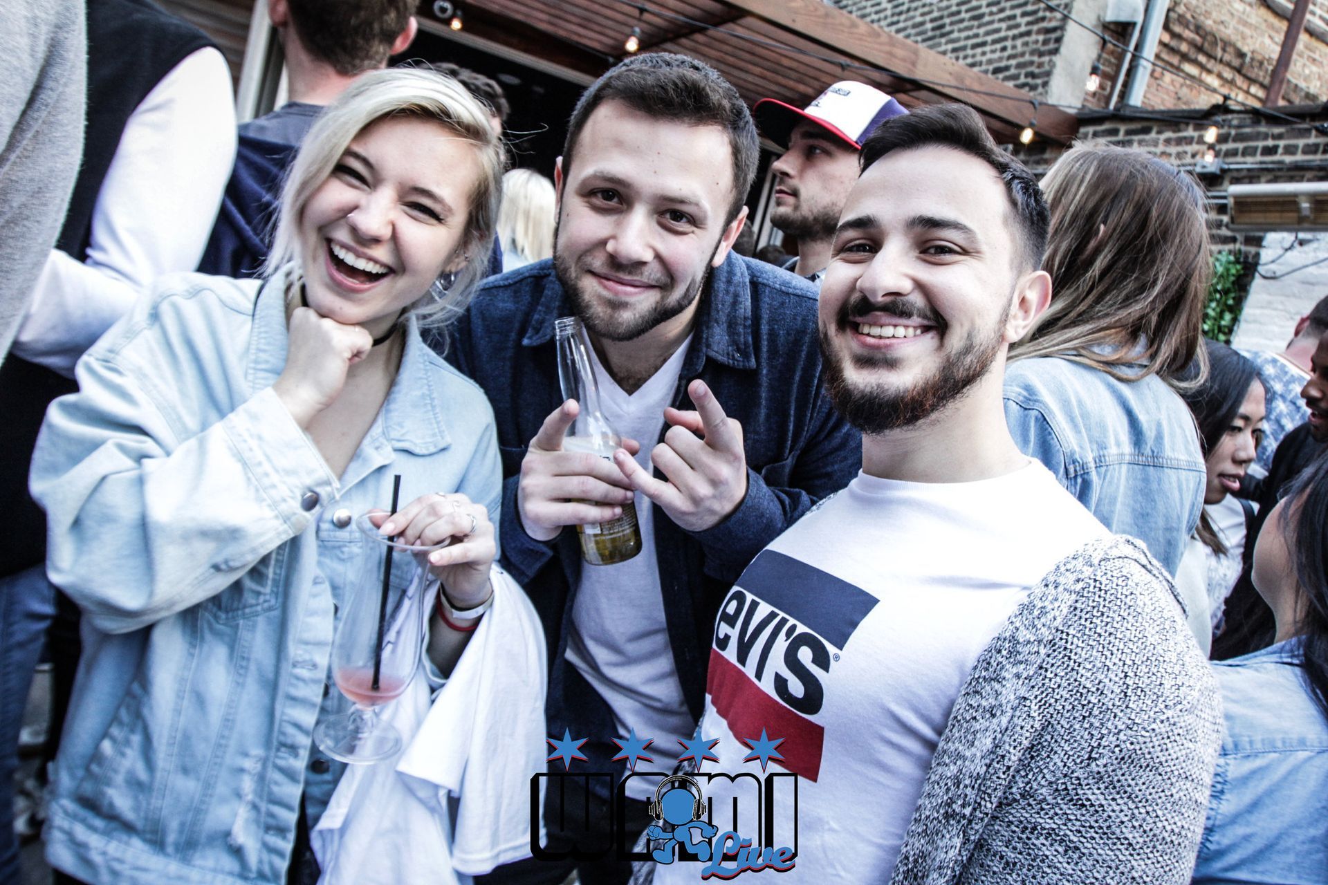 A group of people are posing for a picture in a crowd.