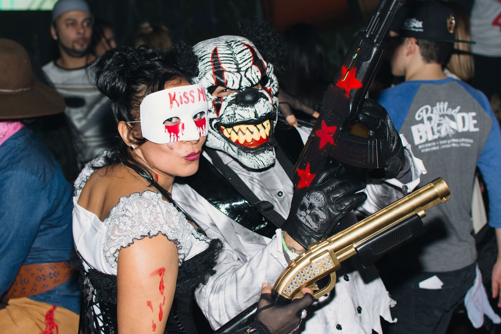 A woman is wearing a mask that says kiss me