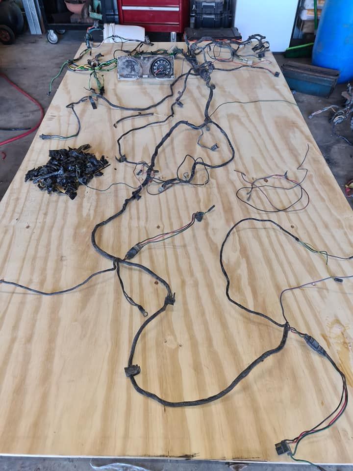 A bunch of wires are laying on a wooden table.