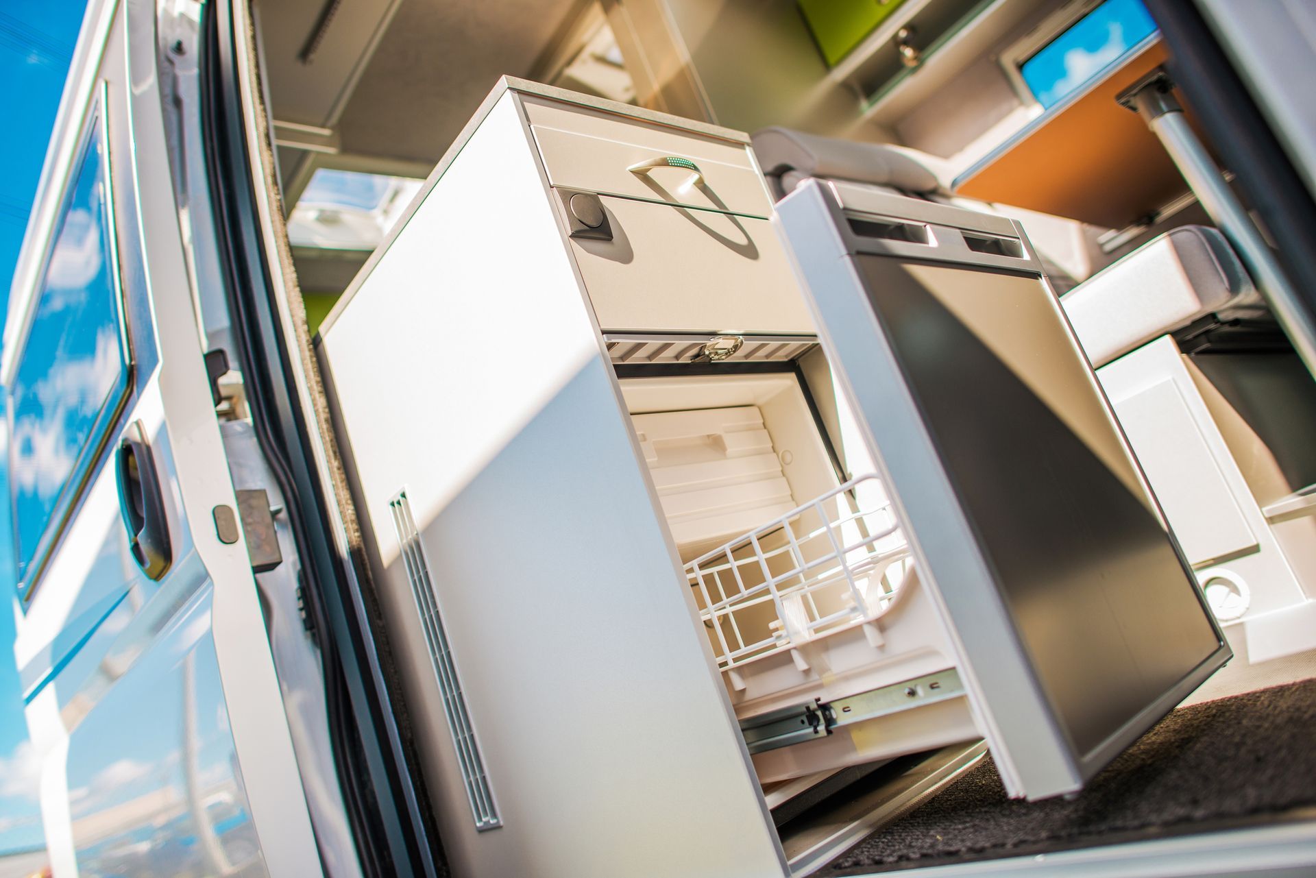 A refrigerator is sitting in the back of a van.