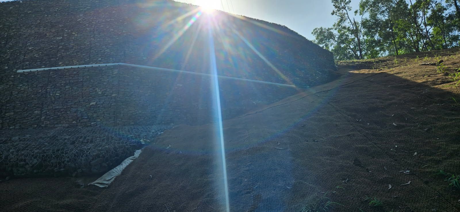 Sun Shining Over a Dirt Covered Hill — STJ Earthmoving in Mareeba, QLD