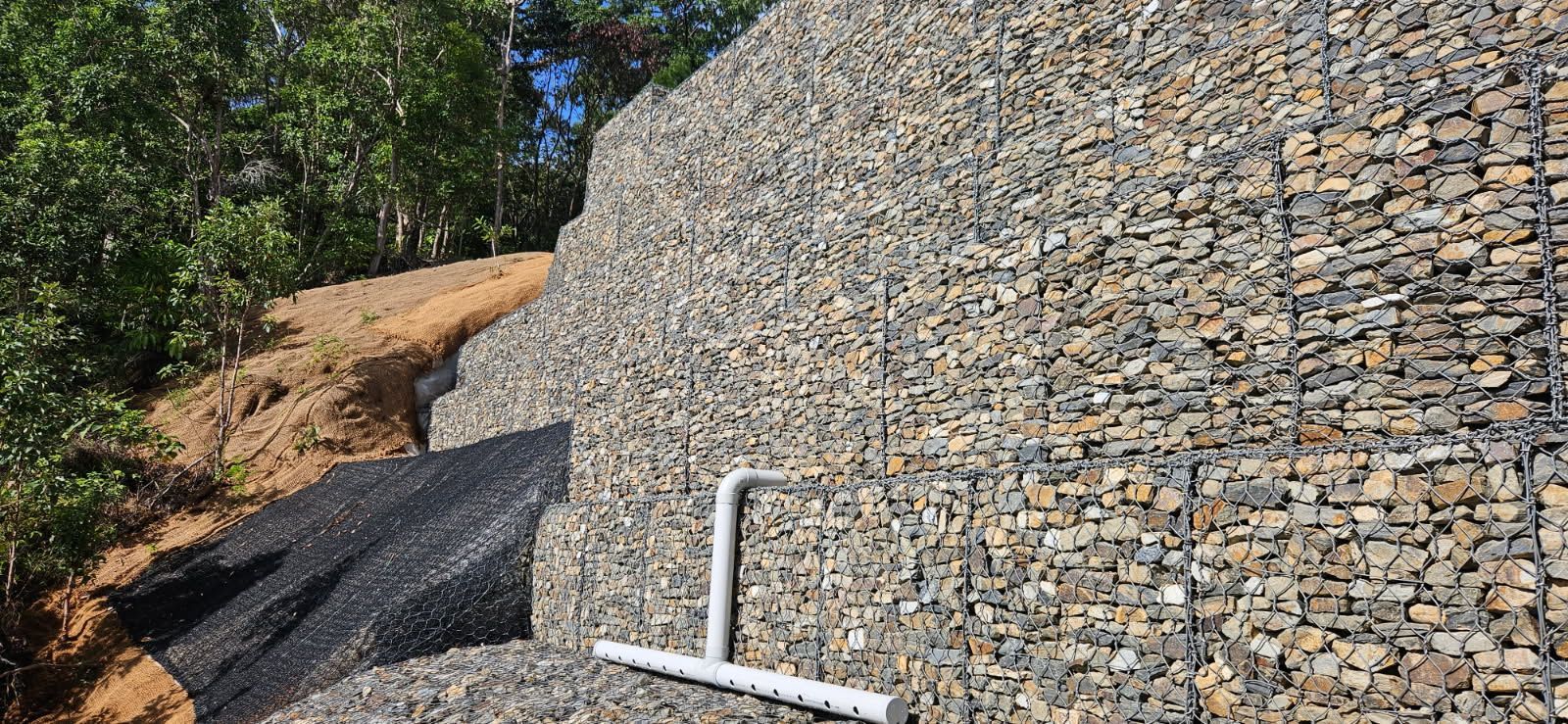A Gabion Wall Supports an Earthen Bank — STJ Earthmoving in Mareeba, QLD
