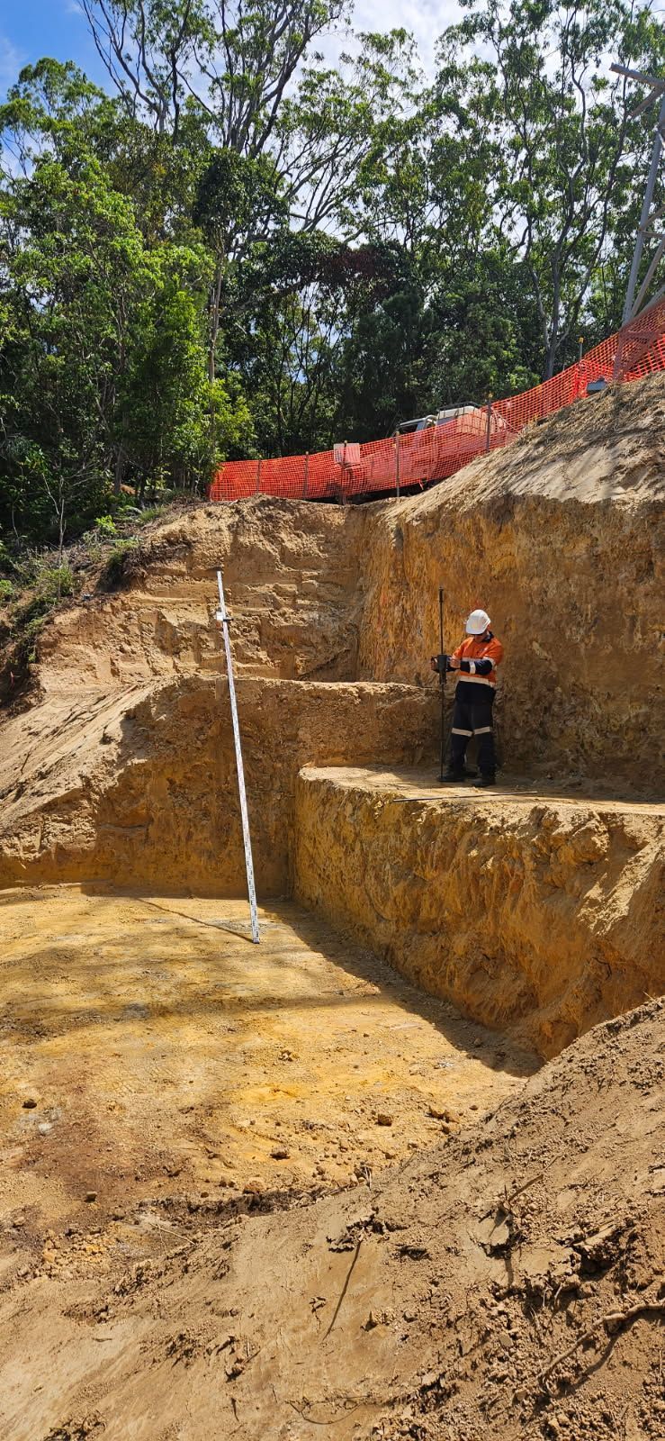 Person in Safety Gear in a Stepped Excavation — STJ Earthmoving in Mareeba, QLD