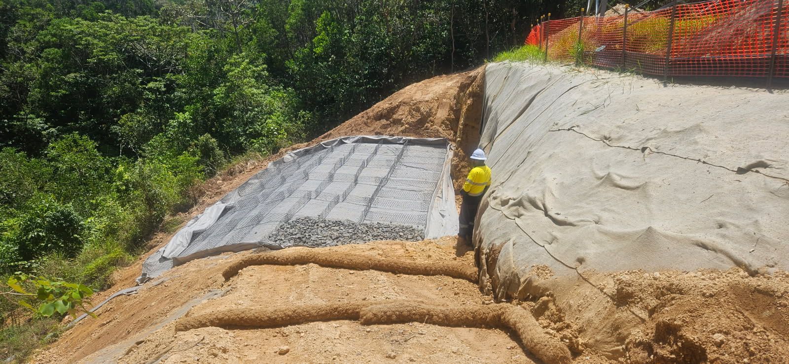 A Construction Worker Stands Near an Excavated Hillside — STJ Earthmoving in Mareeba, QLD