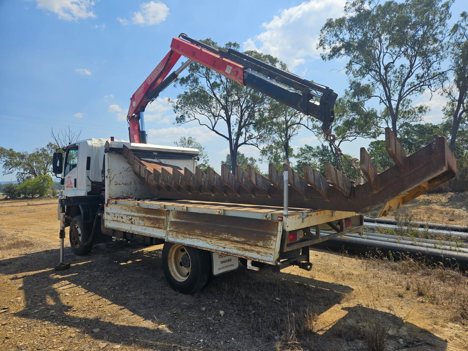 A Flatbed Truck With a Crane Lifting a Large — STJ Earthmoving in Mareeba, QLD