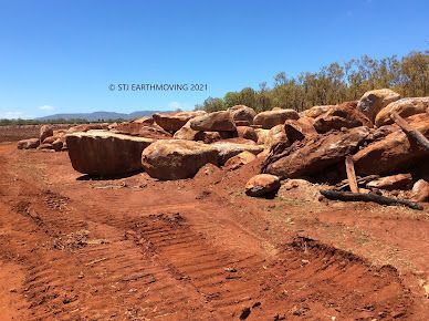 A Pile of Rocks Sitting on Top of a Dirt Road — STJ Earthmoving in Mareeba, QLD
