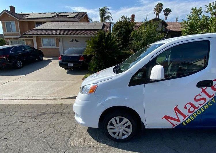 a white van is parked in front of a house .