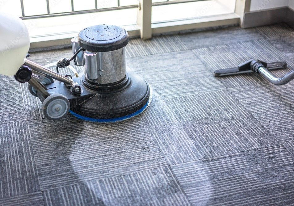 Commercial carpet cleaning expert using a floor buffer to deep clean office carpeting.