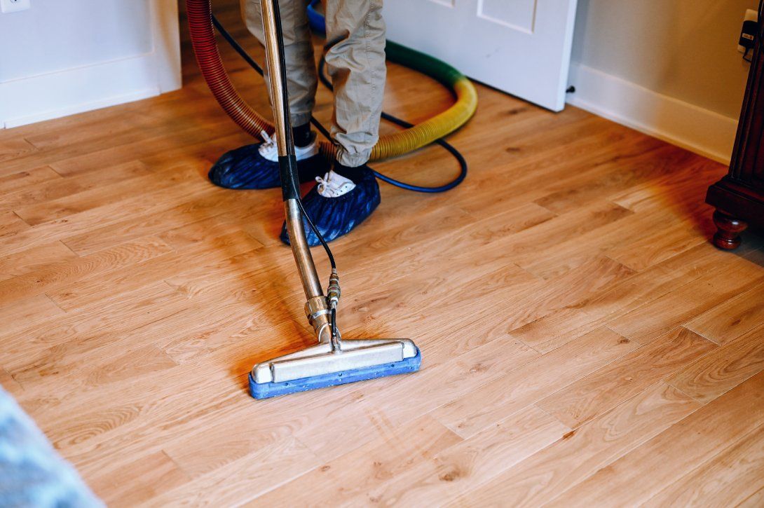 Professional hardwood floor cleaning service using advanced equipment for deep cleaning.