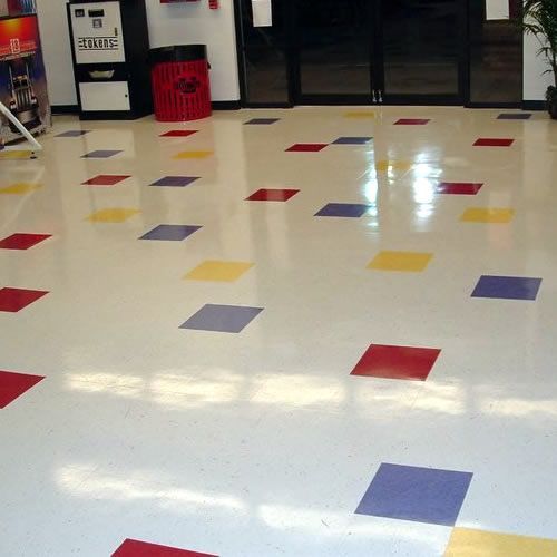 VCT tile floor after expert stripping and waxing, restoring shine and durability for high-traffic commercial areas.