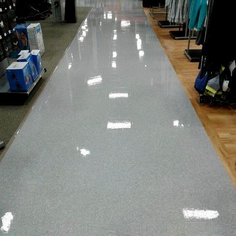 High-gloss VCT floor cleaning and waxing in a commercial retail store for a polished, professional look.