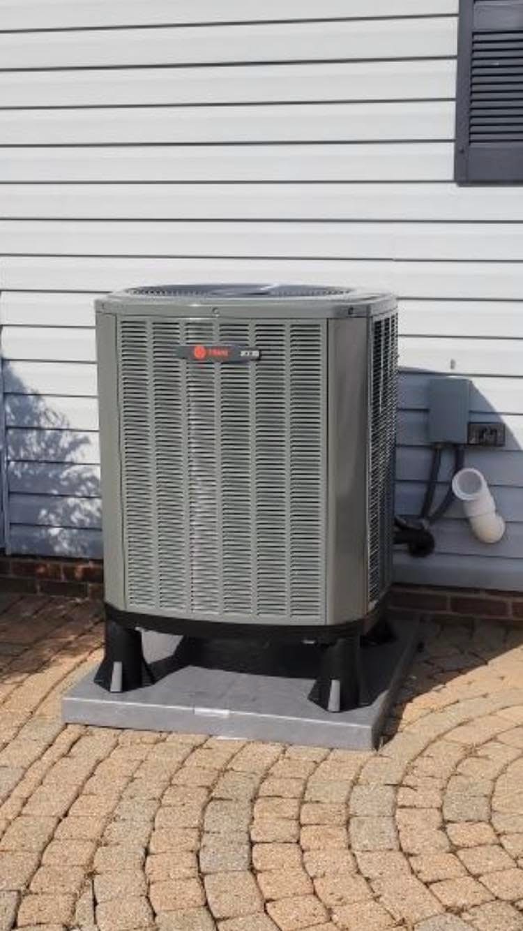 White Air Conditioner on the Side of a Brick Wall