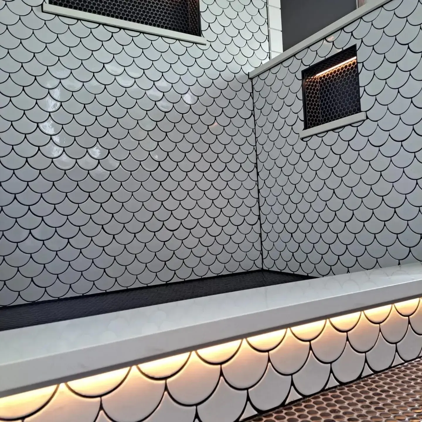 A bathroom with white tiles custom designed