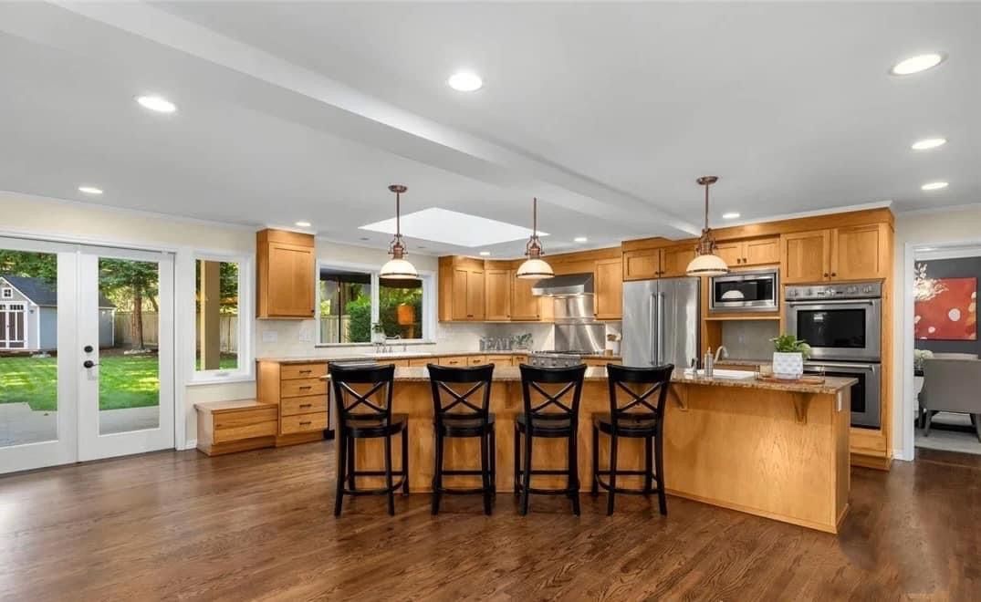 Warm-toned kitchen with wood-look bar counters and matching cabinets, crafted by A&J Remodel and Construction in Houston