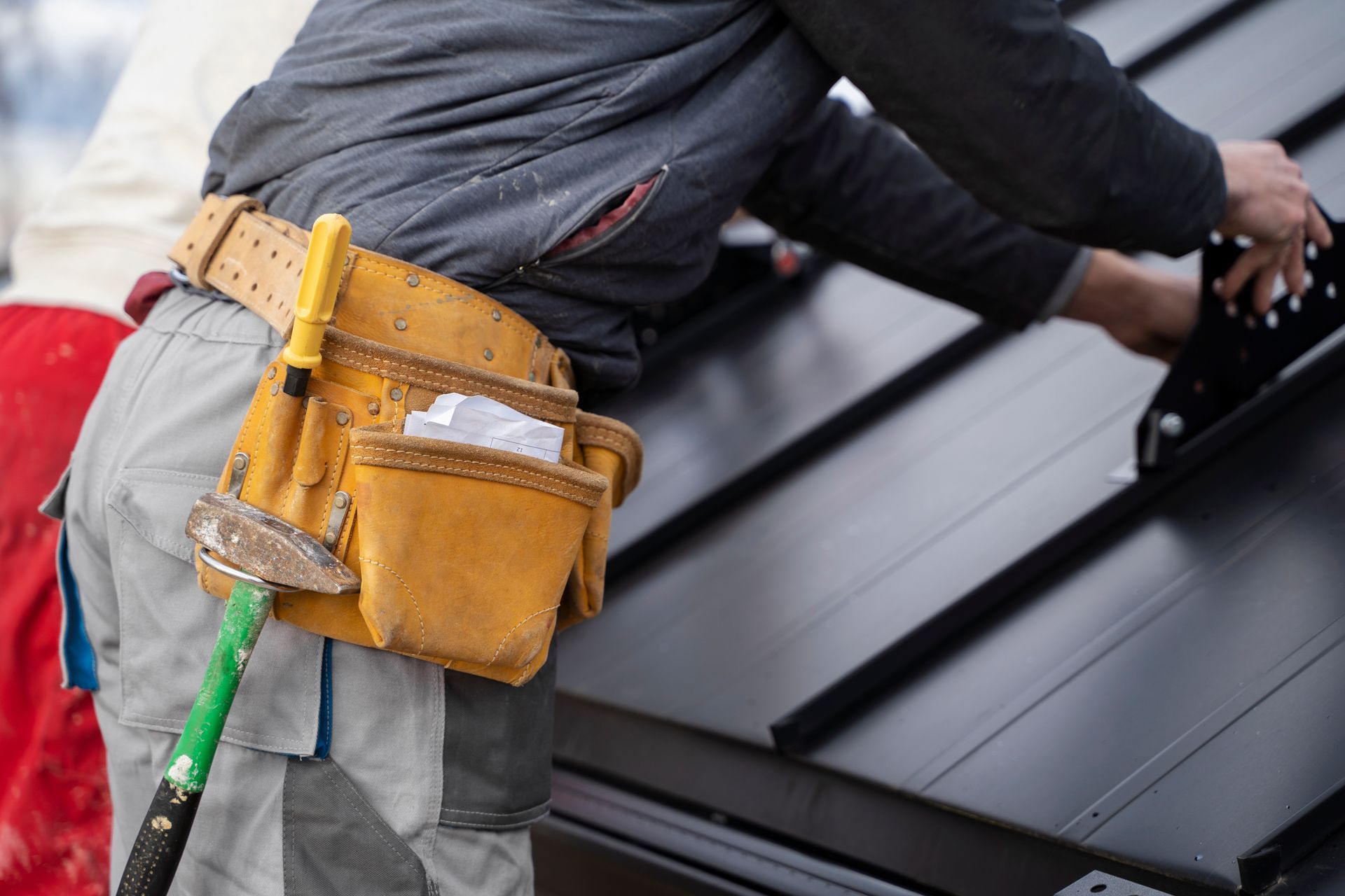A&J Remodel and Construction roofer applying finishing touches to a newly installed roof on a Houston home