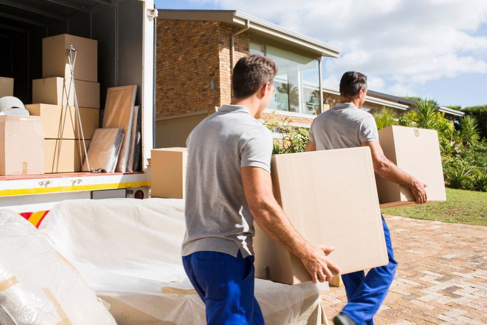 Movers Carrying Boxes In New House
 — Furniture Removals in West Ballina, NSW
