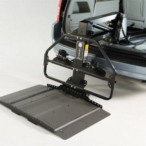 Wheelchair lift installed in a van. Ramp extended, ready for use.