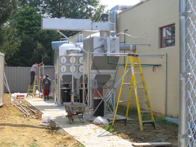 A yellow ladder is sitting in front of a building