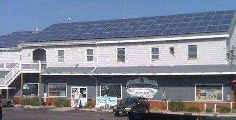A large building with a lot of solar panels on the roof.
