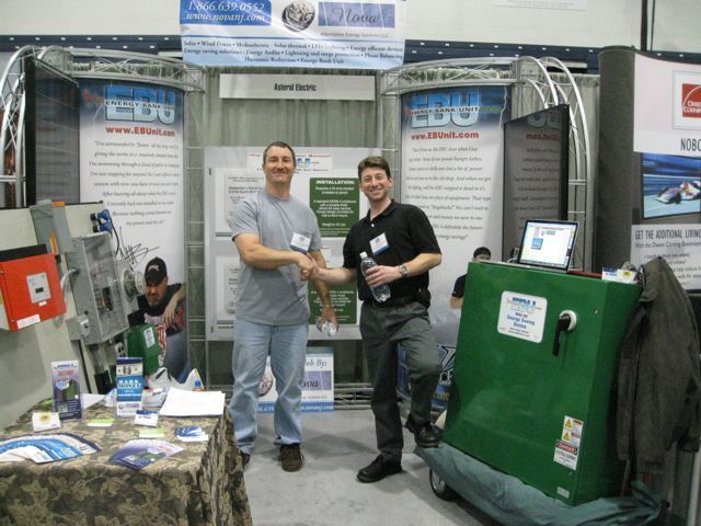 Two men shaking hands in front of a sign that says ' edg ' on it