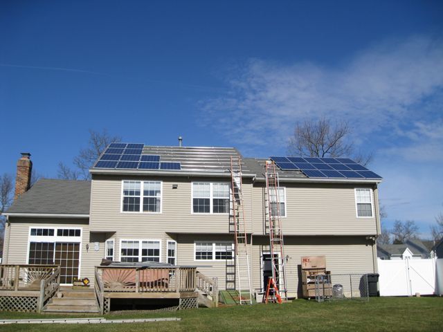 A house with a lot of solar panels on the roof