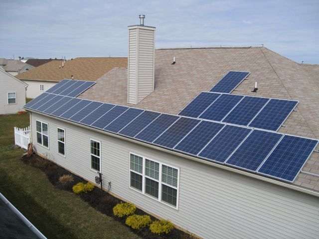 A house with a lot of solar panels on the roof