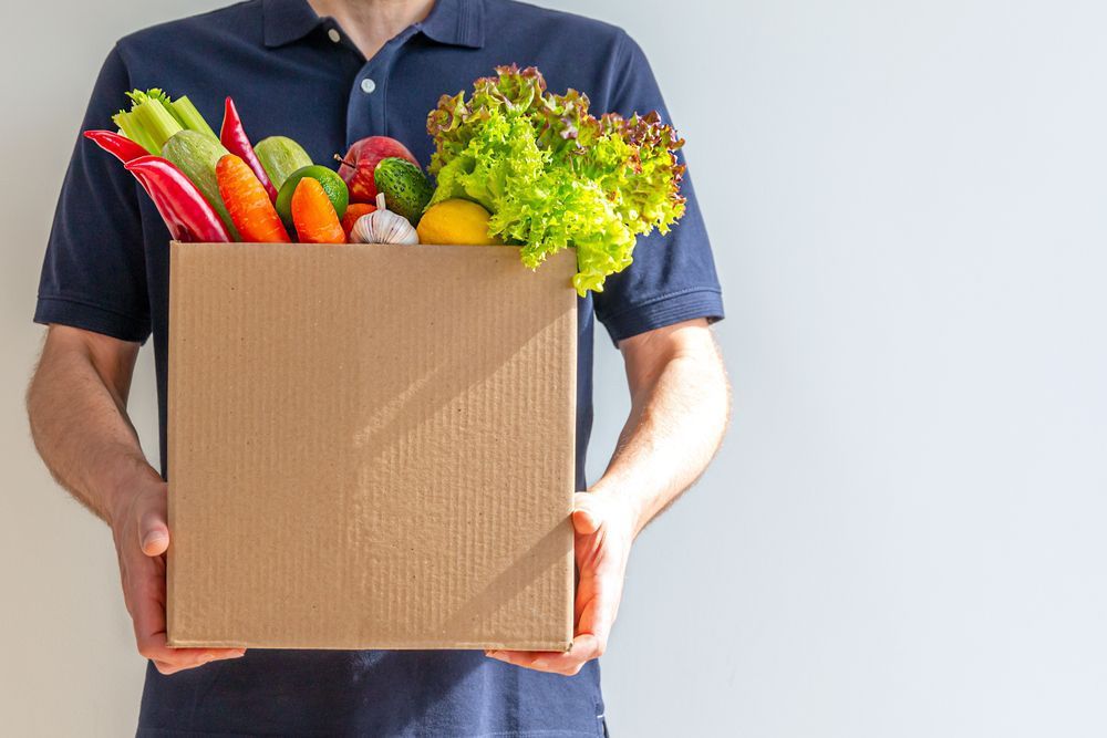 Man With A Cardboard Box Of Fresh Vegetables — Fresh to Door In Fyshwick ACT