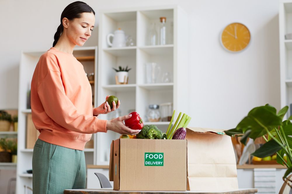 Woman Receiving Food Delivery to Home — Cleaners in Tamworth, NSW