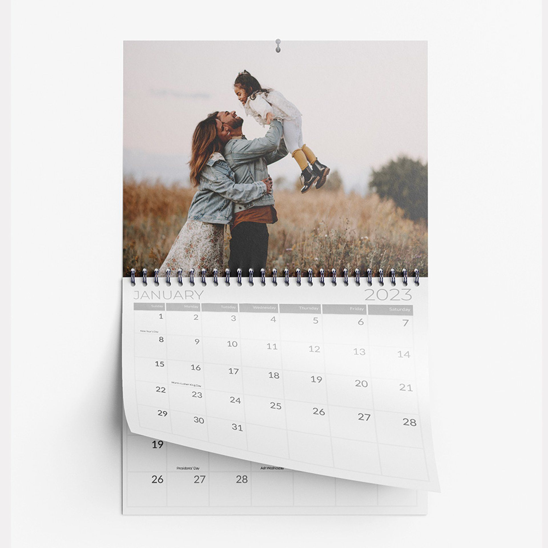 A calendar with a picture of a woman holding a child.