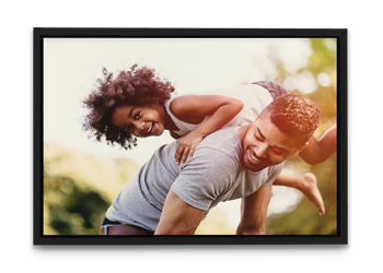 A man is carrying a little girl on his shoulders.