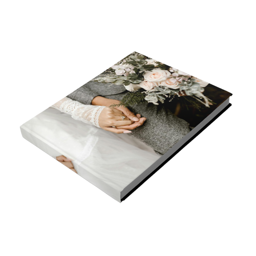 A book with a picture of a bride and groom holding hands