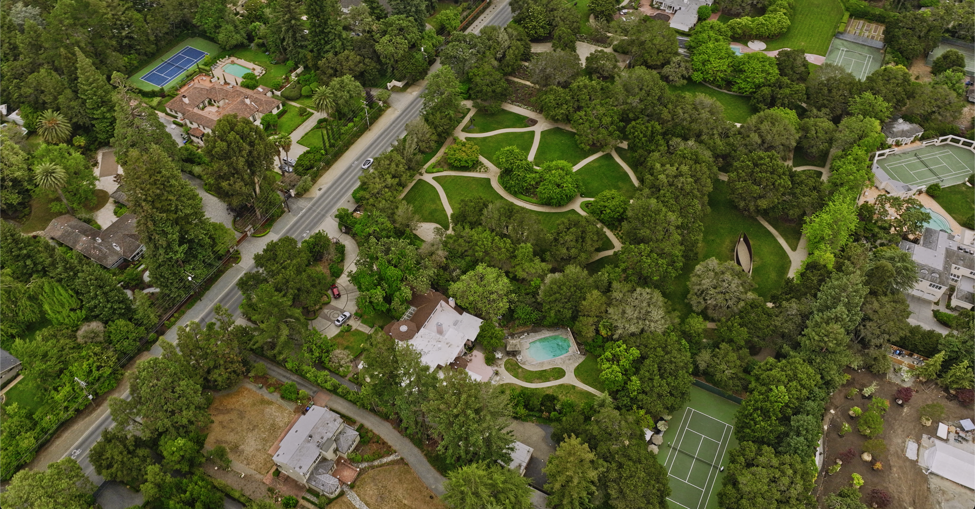A large house with a large swimming pool in front of it