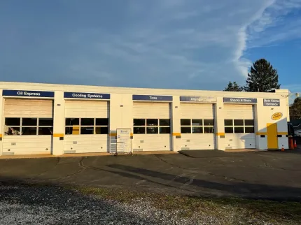 A large white building with a lot of garage doors