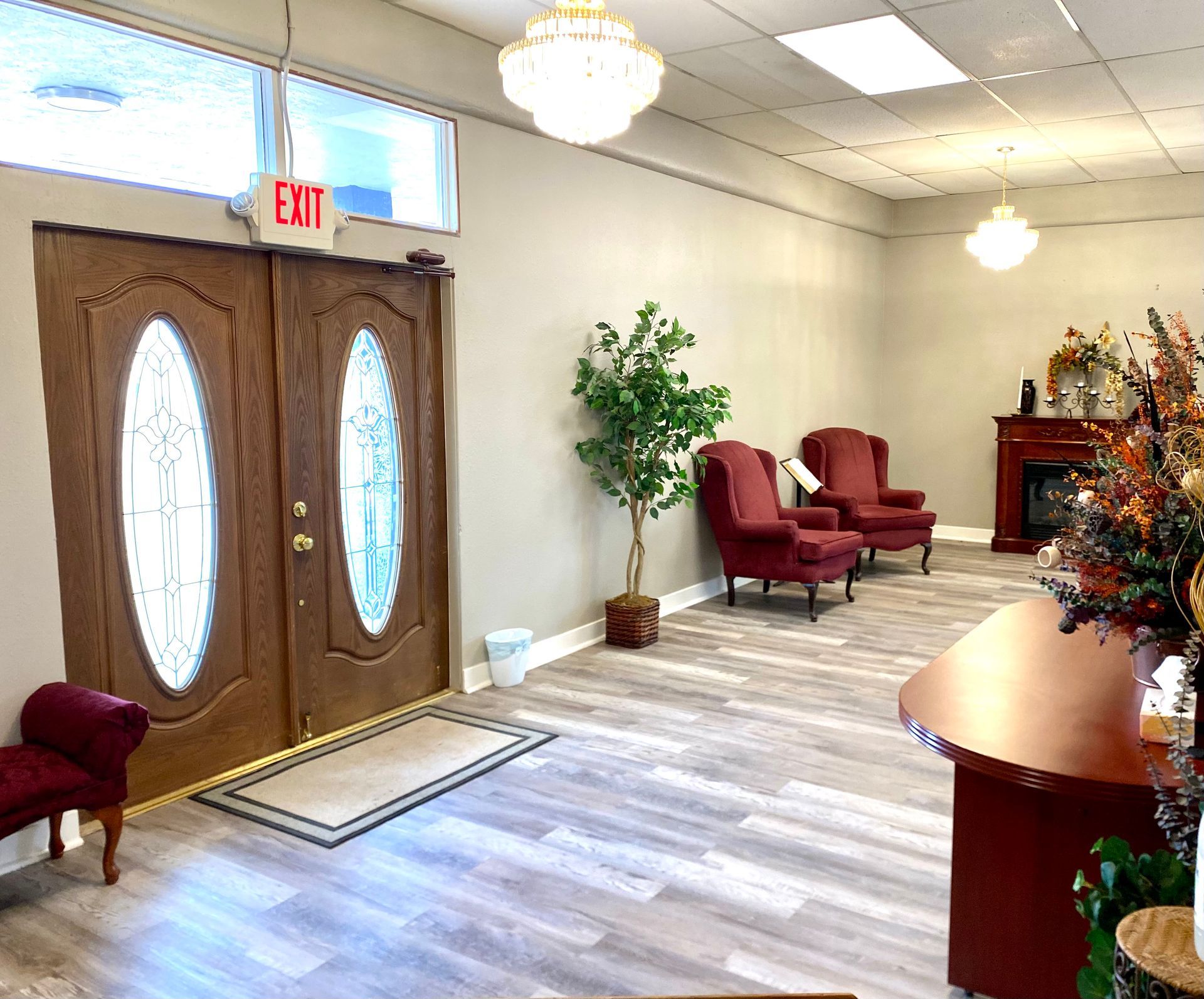 a living room with a fireplace and a chandelier