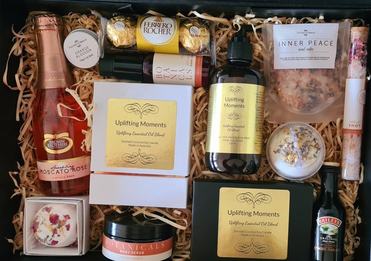 Gift box filled with various self-care items, including champagne, skincare, and bath products.